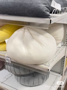 the shelves are filled with different types of pillows