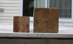 two wooden blocks sitting on top of a cement slab