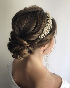 a woman wearing a hair comb with pearls on it