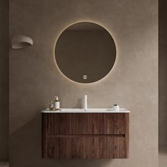 a bathroom with a round mirror above the sink