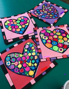 four pieces of art made to look like hearts on green paper with paint and glue