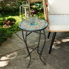 a table with two glass vases sitting on top of it next to a chair