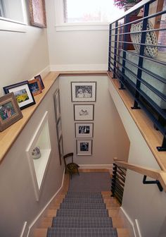 a staircase with pictures and frames on the wall