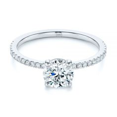 a diamond engagement ring on a white background