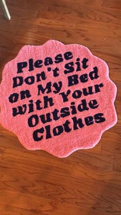 a pink rug that says please, don't sit on my bed with your outside clothes