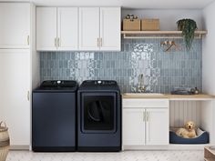 a washer and dryer sitting in a kitchen next to each other on the floor