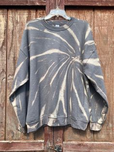 Gray Bleach Dyed Sweatshirt // Bleached Tie Dye // Bleached Loungwear // Grey Acid Washed Sweatshirt Sit back and relax in our comfy sweatshirts. Our sweatshirts are gently hand bleached to create a unique design using a reversed process rather than adding color. This charcoal color shows tones of bronze and heather grey when the color is removed. Each of our items are made to order, and there may be slight variations in design. The process we use to remove the color will ensure your clothing st Tie Dye Cotton Sweatshirt, Hand Dyed Cotton Sweatshirt With Relaxed Fit, Stonewashed Relaxed Fit Sweatshirt For Fall, Fall Stonewashed Relaxed Fit Sweatshirt, Oversized Hand-dyed Cotton Sweatshirt, Relaxed Fit Acid Wash Bleached Top, Acid Wash Relaxed Fit Top, Oversized Bleached Cotton Sweatshirt, Relaxed Fit Hand Dyed Tie Dye Sweatshirt