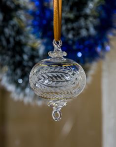 a clear glass ornament hanging from a tree