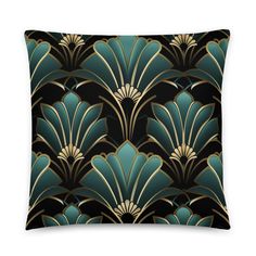 a black and gold pillow with an art deco design on the front, featuring large leaves