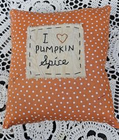 an orange pillow with white polka dots and the words i love pumpkin spice on it