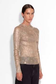 This Crystal Embellished Fishnet Long-Sleeved Top exudes an ultra-feminine aesthetic. With its impeccable craftsmanship, brilliant crystal embellishments, and daring design, this top is perfect for making a provocative and sophisticated statement. Hand sewn Centre back zip  All-over crystals Length: 56cm The model is 5ft 9 and wears a size small Gentle Dry Clean Luxury Tops For Night Out In Spring, Glamorous Sparkling Tops For Fall, Glamorous Embellished Tops For Fall, Sparkling Long Sleeve Top For Fall, Long Sleeve Sparkling Top For Fall, Fall Sparkling Long Sleeve Top, Glamorous Fall Tops With Rhinestones, Chic Fitted Sparkling Tops, Chic Embellished Evening Tops