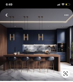 an image of a kitchen with blue walls and marble counter tops, bar stools