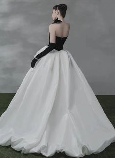 This stunning Gothic Black and White Off Shoulder Wedding Dress will make you stand out at your special event. Featuring an off-shoulder design and a full-length cut, this dress is crafted from a lightweight and high quality material. The bodice features an intricate lace design throughout with a delicate black ribbon trim to highlight the beautiful design. The skirt features an elegant and voluminous design, with a long train that adds a dramatic touch. The included gloves complete the look, ma Black And White Masquerade Dress, Black And White Ballgown, Wedding Dress With Black Gloves, Black And White Gala Dresses, Wedding Dress Black Gloves, Black And White Dresses Formal, Black And White Gown Elegant, Black And White Gowns, Black And White Ball Gown