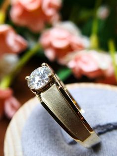 a diamond ring sitting on top of a table