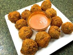 some food on a white plate with a dipping sauce