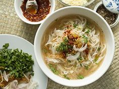 several bowls of food on a table with chopsticks