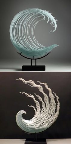 an artistic sculpture is displayed in front of a dark background with white swirls on it