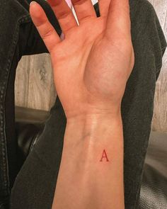 Letter A Initial Tattoo, Red Ink Letter Tattoo, Letter E Finger Tattoo, Small A Tattoo Letter, Red Initial Tattoo, Initial Tattoo Men, Initial Tattoo Wrist, Red Tattoos Men, Finger Letter Tattoo