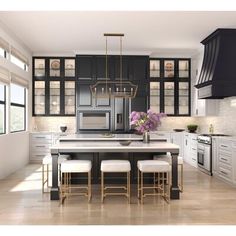 a large kitchen with black cabinets and white counter tops