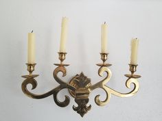 a wall mounted candle holder with five candles