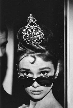 a woman wearing sunglasses and a tiara