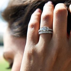 a close up of a person's hand with a wedding ring on their finger