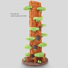 an interactive tree house for cats to play and rest on the ground, with trees growing out of it