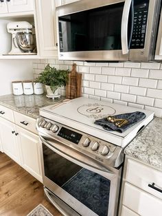 a stove top oven sitting inside of a kitchen next to a microwave and countertop