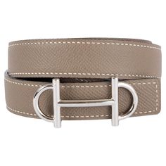 100% authentic Hermes Gamma 24mm reversible belt in Etoupe (taupe) Epsom and black Veau Epsom swift leather with palladium buckle. Has been worn and is in excellent condition. Comes with box. Measurements Tag Size 85 Width 2.5cm (1in) Fits 82cm (32in) to 87cm (33.9in) Length 99cm (38.6in) Buckle Size Height 3cm (1.2in) Buckle Size Width 6cm (2.3in) All our listings include only the listed item unless otherwise specified in the description above. Luxury Business Belt With Tang Buckle, Luxury Business Belts With Tang Buckle, Luxury Formal Belt With Tang Buckle, Classic Beige Belts For Formal Occasions, Classic Beige Belts For Formal Wear, Elegant Brown Belt With Silver Buckle, Luxury Silver Belts With Palladium Hardware, Luxury Leather Belts With Silver Buckle, Luxury Formal Belt With Silver Buckle