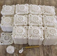 white crocheted doily sitting on top of a wooden floor next to a pair of scissors