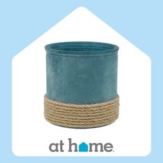 a blue pot sitting on top of a rope