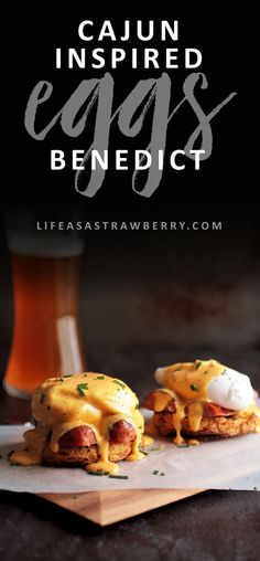 two eggs benedicts with bacon and cheese are on a cutting board next to a glass of beer