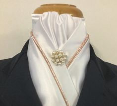 The HHD Custom White Stock Tie with rose gold piping, a gathered centre and a pearl rhinestone pin  This stock tie can also be made in Ivory Satin Hand Made in Australia by Heavenly Horse Designs  www.heavenlyhorsedesigns.com.au The neckband measures 15-17" or 40-42cm, if you require a different size please send a message  Hand Washable Dressage Stock Tie, Equestrian Dressage, Stock Tie, Satin Hands, Satin Noir, Rose Gold Pearl, Pearl Pin, Satin Roses, Gold Flecks