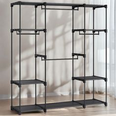 a black shelving unit with three shelves on each side and one shelf in the middle