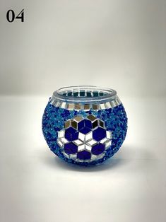 a glass vase with blue and white designs on it