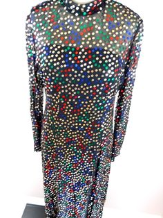 "This is an elegant 1970's vintage evening gown by Pat Sandler. It is beautifully embellished with sequins on a sheer shell and also has a slip underneath. It's in excellent condition! Bust - 34/36\" Waist - 28/30\" Hips - 36/38\" Total Length - 54\" This dress comes from a pet-free and smoke-free home. If you would like more info or have any questions, please don't hesitate to ask!" Multicolor Sequin Dress For Formal Occasions, Multicolor Sequin Dresses For Formal Events, Formal Multicolor Sequined Dresses, Glamorous Multicolor Sequin Fabric For Evening, Multicolor Sequined Maxi Dress For Party, Elegant Multicolor Sequin Fabric For Evening, Festive Fitted Sequin Maxi Dress, Festive Fitted Maxi Dress With Sequins, Embellished Multicolor Maxi Dress For Party