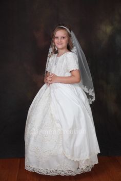 Our Maryann First Communion Dress is one of my newest creations. Made in fine soft taffeta, french lace and fully lined on the inside. Dress features Victorian style Beaded Lace. Dress is full length, features cap sleeves and rhinestone waist decoration. Veil Sold Separate. Larger sizes can be made at an additional cost. Made in Downtown Los Angeles LIMITED EDITION READY TO SHIP Disclaimer: Be aware that lighting may change colors, photographer styles can do that to images, but we guarantee that Fitted Short Sleeve Gown For Confirmation, Fitted Gown With Short Sleeves For Confirmation, Beaded Lace Dress, First Communion Dress, Lace Gloves, French Lace, First Communion, Beaded Lace, Victorian Style