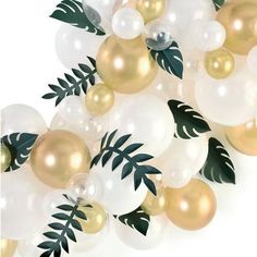 white and gold balloons with green leaves on them