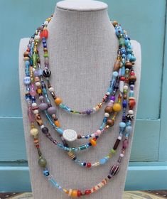 "This showstopping jewelry set is handmade from a variety of high-quality glass beads, including millefiori beads. The necklace has five strands in a true rainbow of colors and parade of shapes and sizes. Includes a matching bracelet and earrings. The bracelet is currently 7.5\", but I would be happy to customize for you." Cheap Multicolor Strand Jewelry, Artisan Multi-strand Multicolor Beaded Bracelets, Colorful Adjustable Multi-strand Jewelry, Artisan Multicolor Multi-strand Beaded Bracelets, Artisan Multicolor Multi-strand Beads, Multicolor Czech Glass Jewelry For Festivals, Spiritual Multi-strand Czech Glass Jewelry, Multicolor Czech Glass Gemstone Beads, Bohemian Rainbow Glass Jewelry