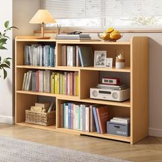 a bookshelf filled with lots of books next to a lamp and a window