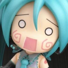 a close up of a toy doll with blue hair and an expression on it's face