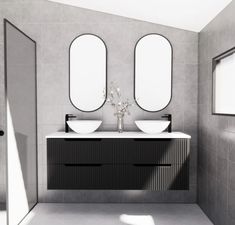 a bathroom with two sinks and mirrors on the wall