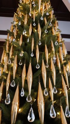 a christmas tree decorated with gold and silver ornaments