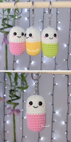 crocheted keychains with two different colors and eyes on them hanging from a hook