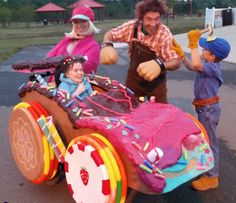 a man and two children are playing with a homemade toy car