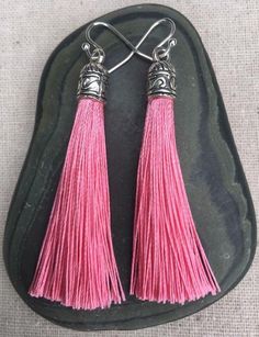 Chic pink tassel earrings!  They would add a pop of color to any outfit for any occasion.  Dress them up or down.  They are timeless and versatile.  They are lightweight, fun and unique!The tassels measure 2 1/8” long by 1/4” wide.  They hang from simple silver ear wire hooks.  Overall drop length is about 2 1/4”.  Metal is allergy free plated silver.These are my latest creation!  I have them available in many colors!  Find them all under the category tassel earrings in my shop.Thanks for stoppi Pink Tassel Earrings As Gift, Pink Tassel Earrings For Gift, Pink Dangle Tassel Earrings For Gifts, Pink Bohemian Tassel Earrings, Pink Tassel Jewelry As A Gift, Pink Earrings With Latkans For A Gift, Pink Latkans Earrings For Gift, Acorn Jewelry, Pink Statement Earrings