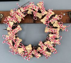 a dog bone wreath with red and white candy canes