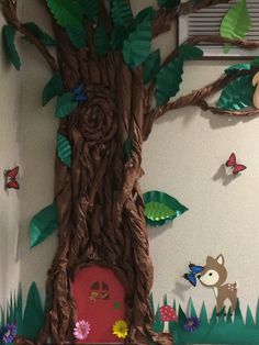 there is a tree that has been made out of paper and some other things on the wall