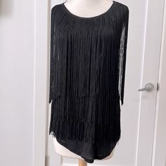 Black T-Shirt Material Sleeveless Top With Layers Of Long Black Fringe. Very Swingy If You Need That Kind Of Energy In Your Life! New With Tags. Sleeveless Fringe Tops For Night Out, Fitted Sleeveless Tank Top With Fringe, Fitted Sleeveless Fringe Tank Top, Black Sleeveless Tank Top For Party, Sleeveless Fringe Tank Top For Party, Sleeveless Party Tank Top With Fringe, Party Fringe Sleeveless Tank Top, Party Fringe Tank Top, Sleeveless Black Top With Fringe