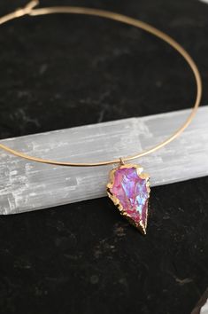 Another version of our most-loved gold choker with arrowhead pendant, this Pink Aura necklace is the most beautiful pink choker! Wear this with our beautiful Heart Work Earrings (as seen in photos) and remember that your "Heart Work" is to be authentically you. Wear this beauty with their matching Pink Aura Earrings as seen in photos. Pink Aura Quartz connects to all of the body's Chakras. It holds a potent, dynamic energy that uplifts, enhances, and brings out your true essence. Pink Aura Quart Pink Choker Jewelry For Festival, Gold Arrowhead Jewelry For Gift, Gold Arrowhead Jewelry Gift, Pink Festival Choker Necklace, Unique Pink Jewelry For Festivals, Pink Bohemian Choker Jewelry, Pink Aura Quartz, Aura Necklace, Work Earrings